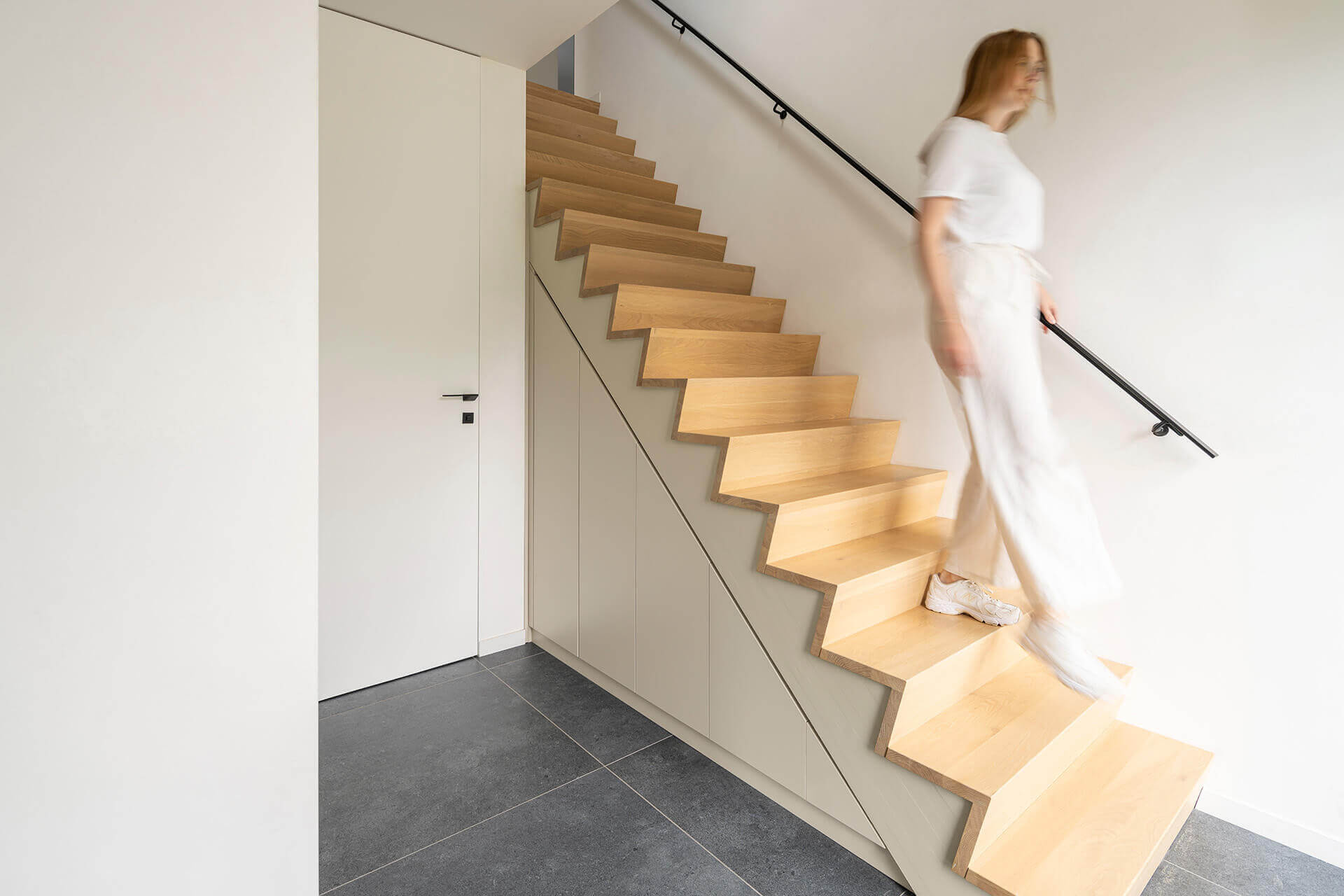 Custom cabinet under the stairs in the color Turtle Grey