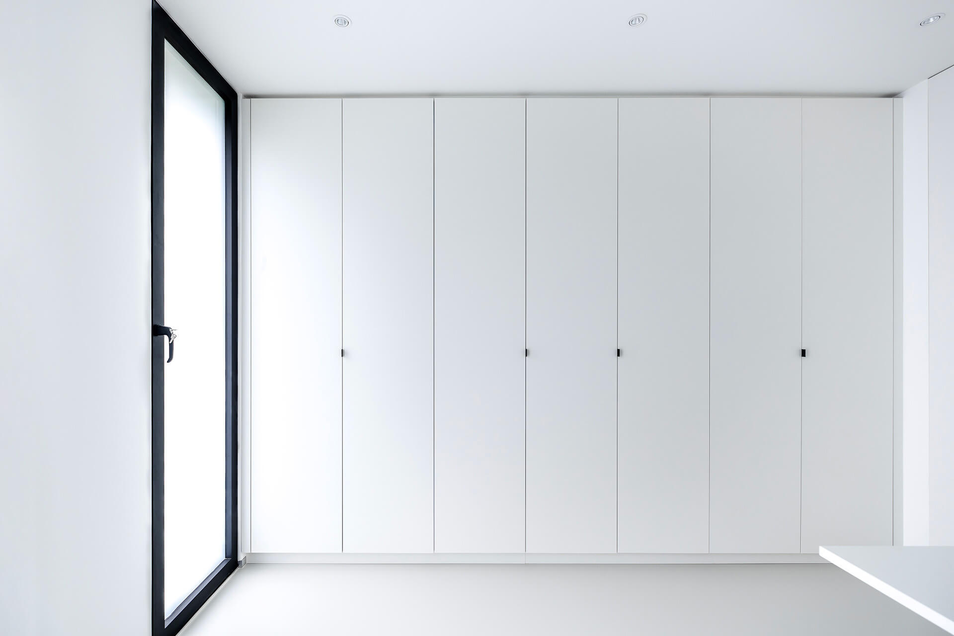 White built-in bespoke storage cupboard from maatkastenonline
