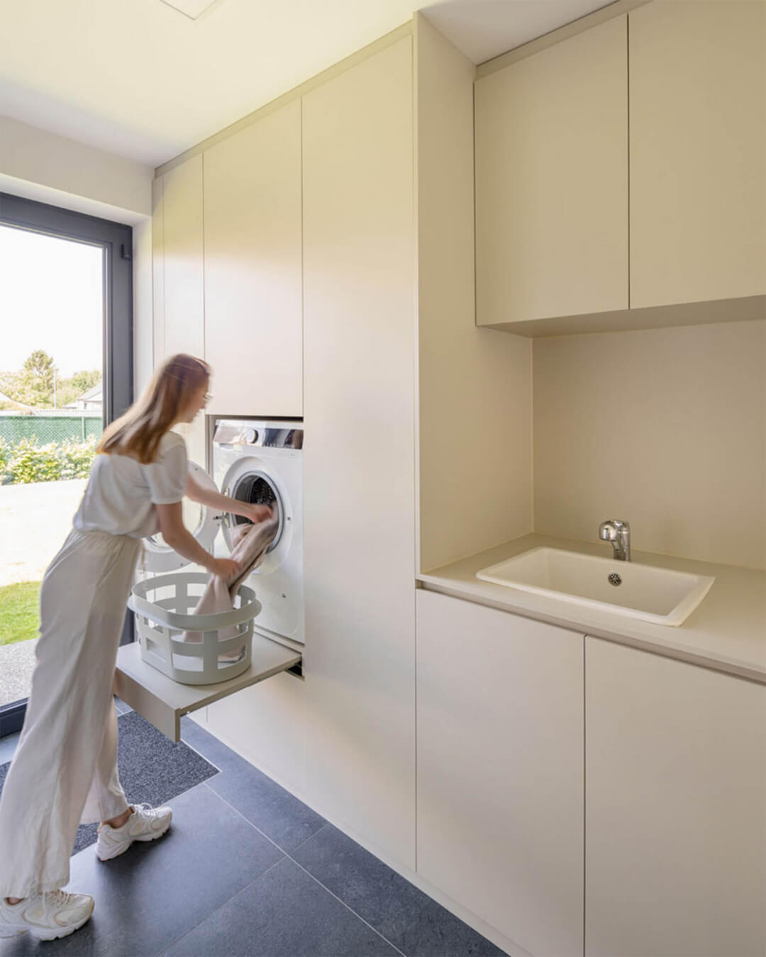 Custom laundry cabinet with washing machine at height, in the color Turtle Grey