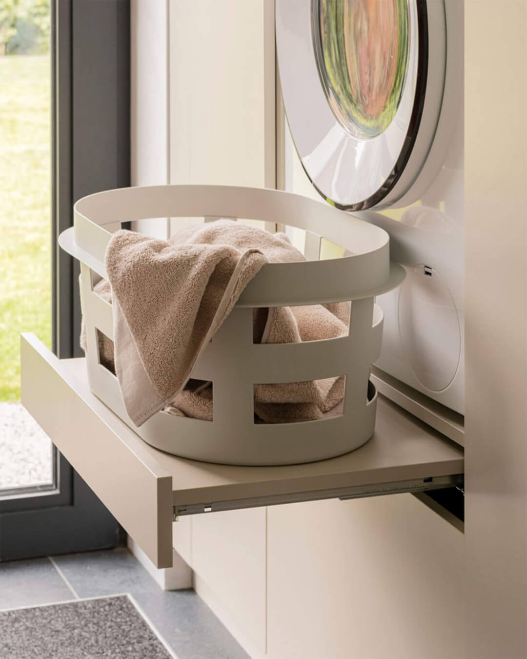 Custom laundry cabinet with pull-out shelf, in the color Turtle Grey