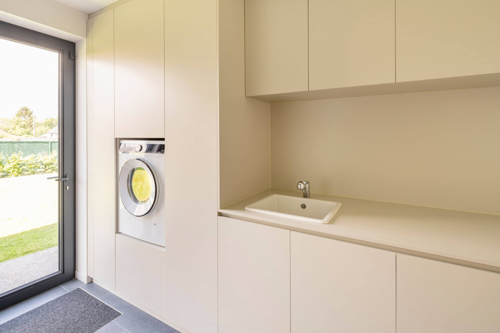 Laundry room with custom cabinets and built-in washing machine, in the color Turtle Grey