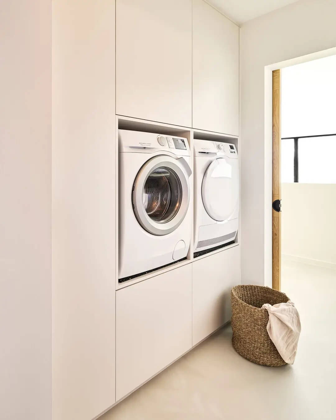 Built-in washing machines in a custom laundry cabinet