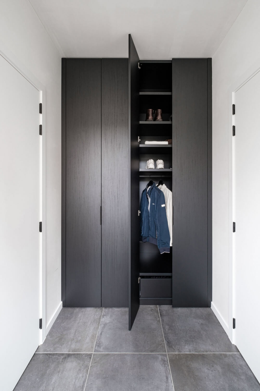 Custom black cloakroom cupboard with black Pure handles