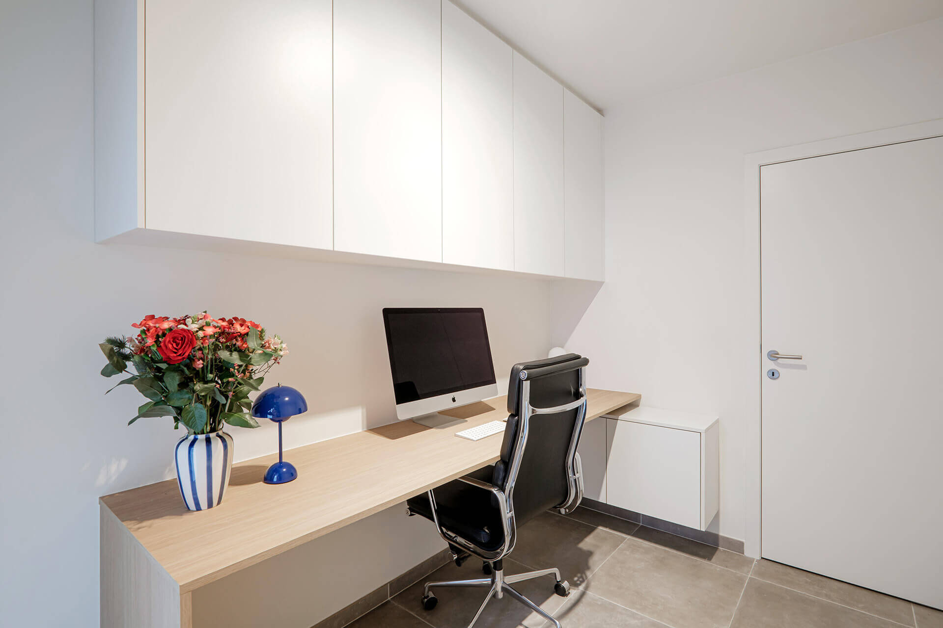 Custom ceiling cabinet above a desk in the color Front White