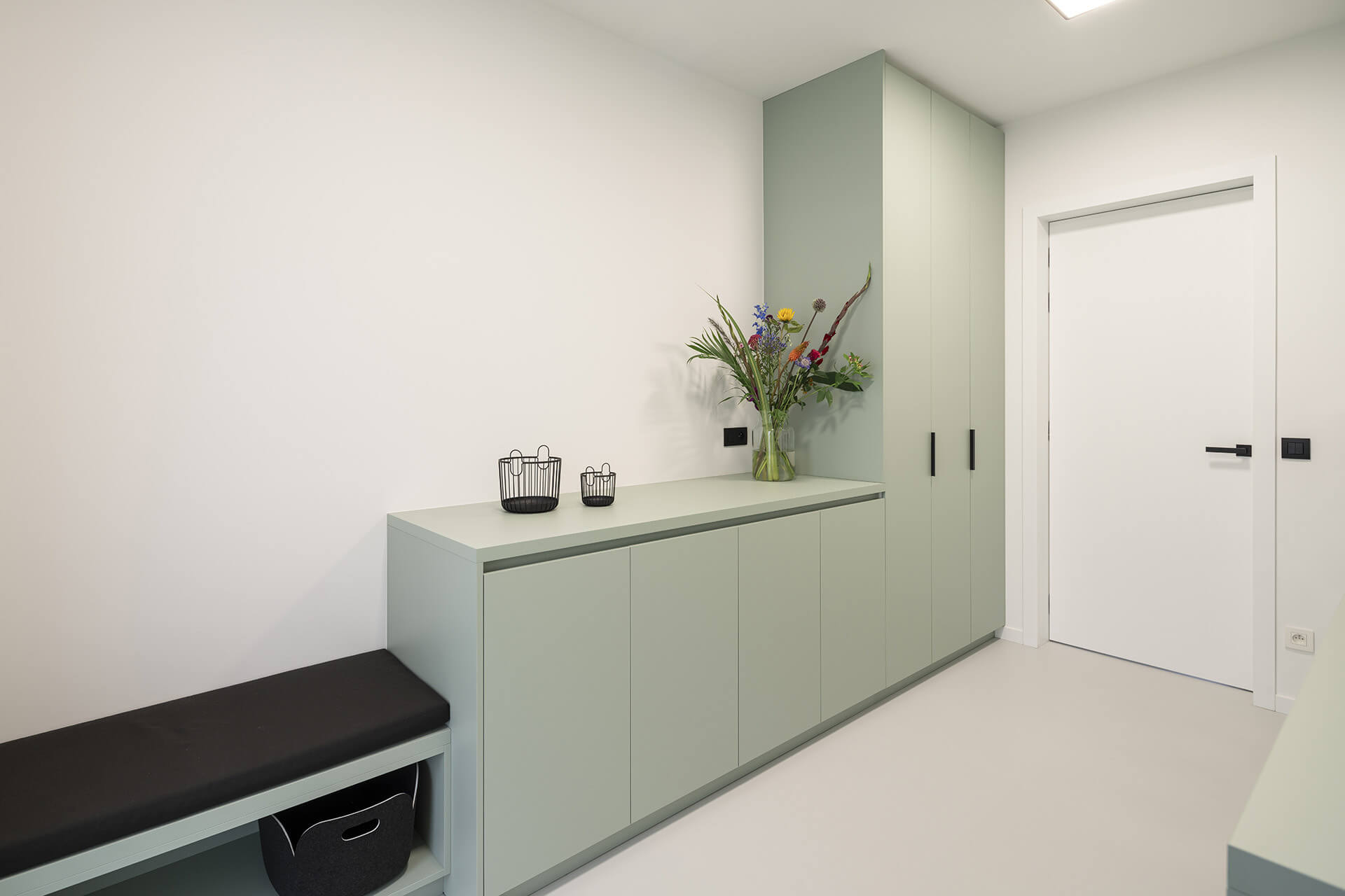 Storage cupboard in the laundry room in Industrial Green 