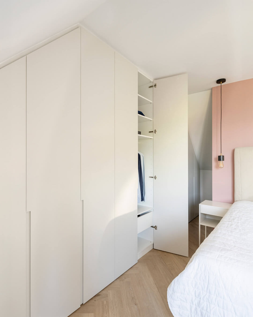 Wardrobe with milled handles, for the bedroom under a slanted roof