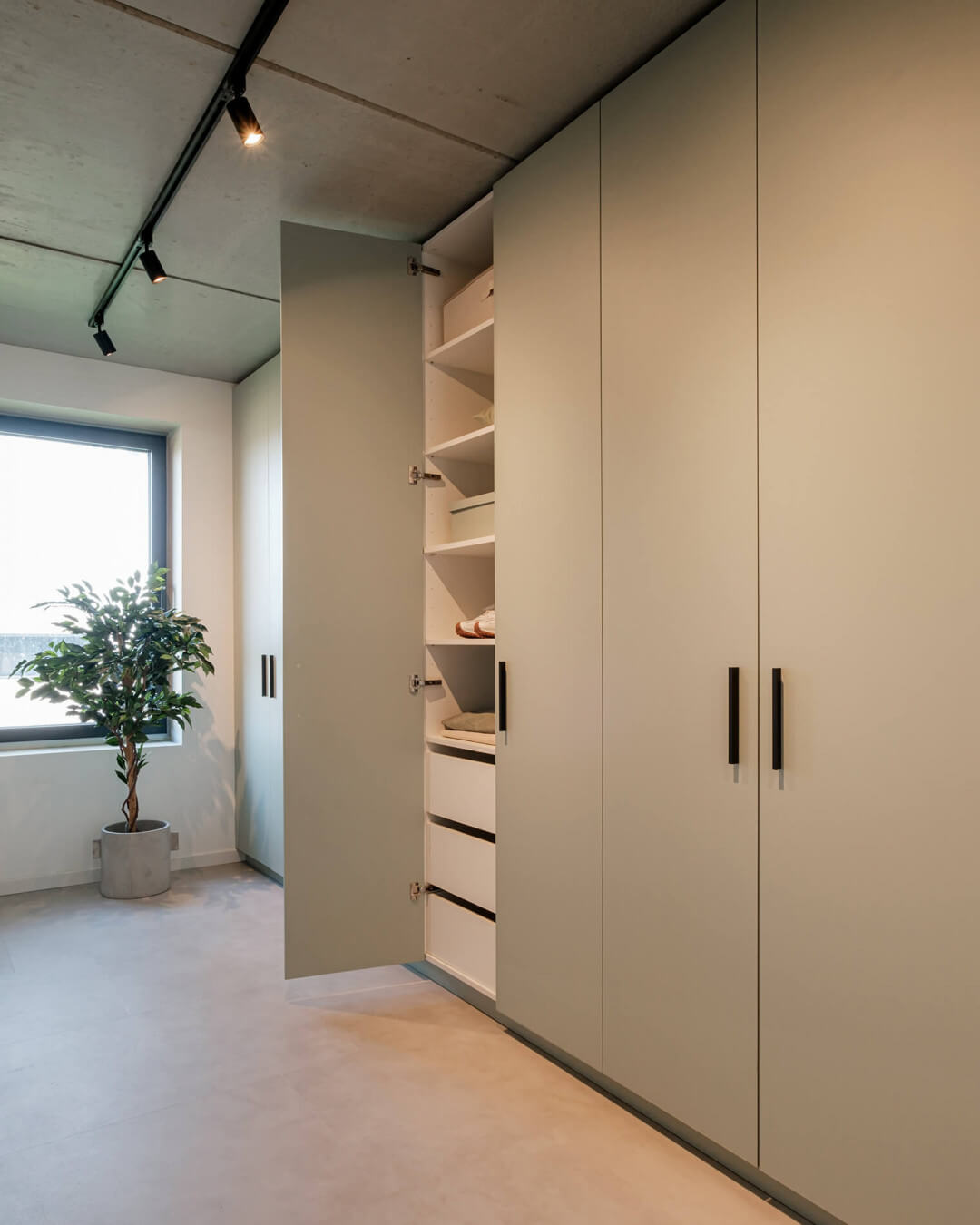 Storage cabinet in the colour Industrial Green with black Bar handles