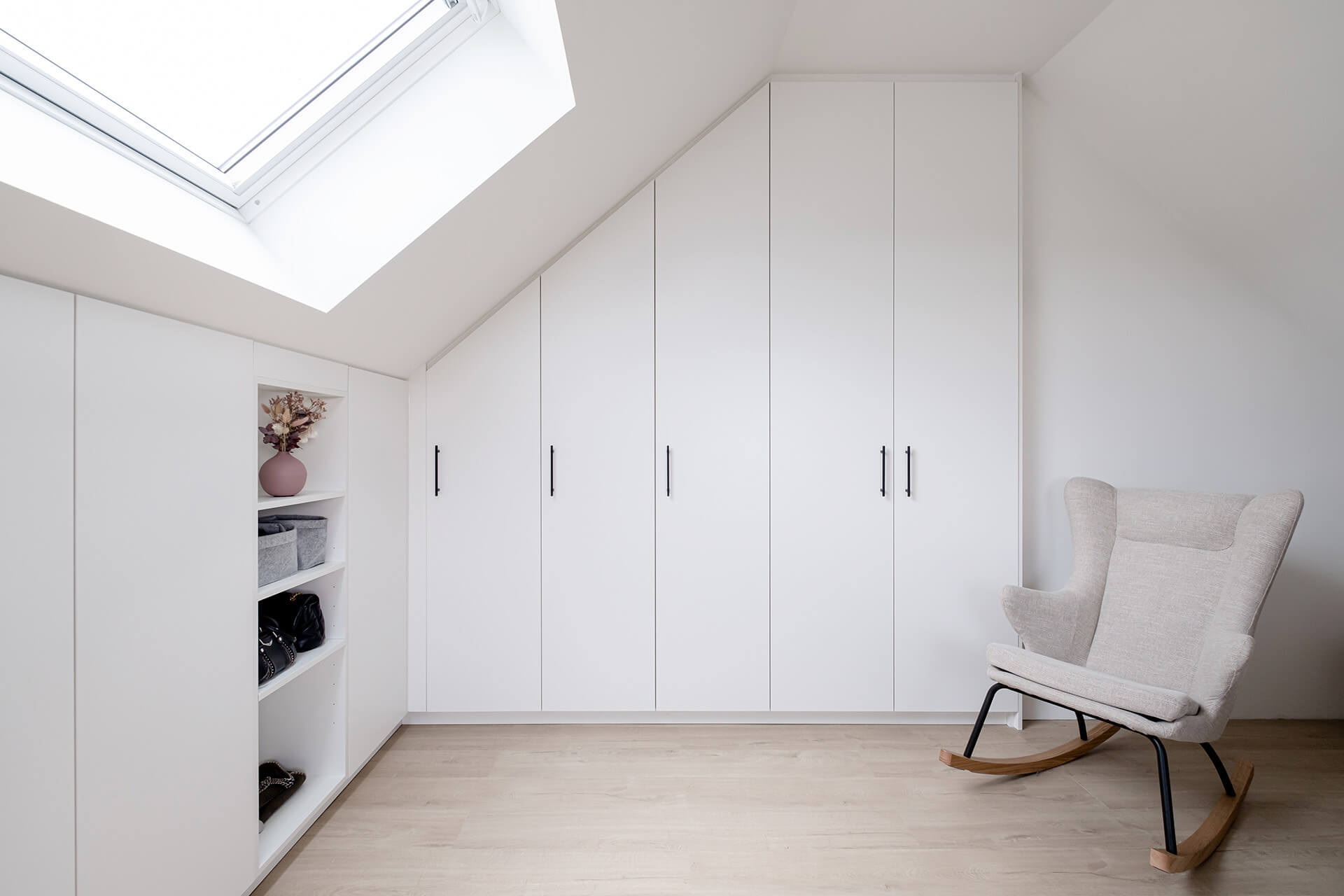 Built-in wardrobe with sloping side and storage cupboard with sloping back under the roof.