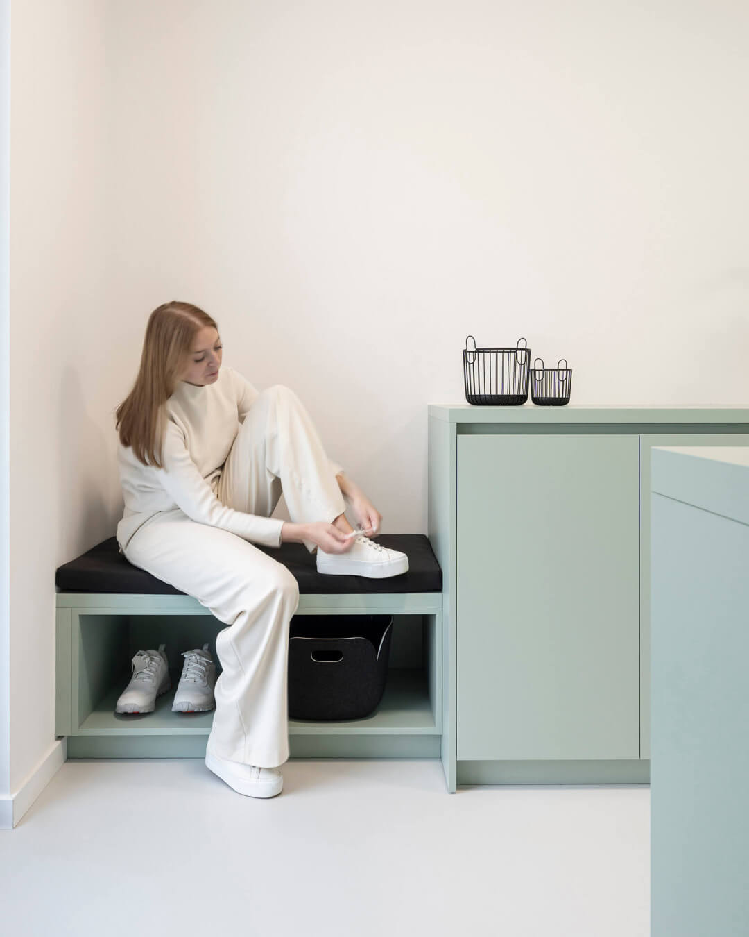 Storage bench in the colour Industrial Green, in the laundry room 