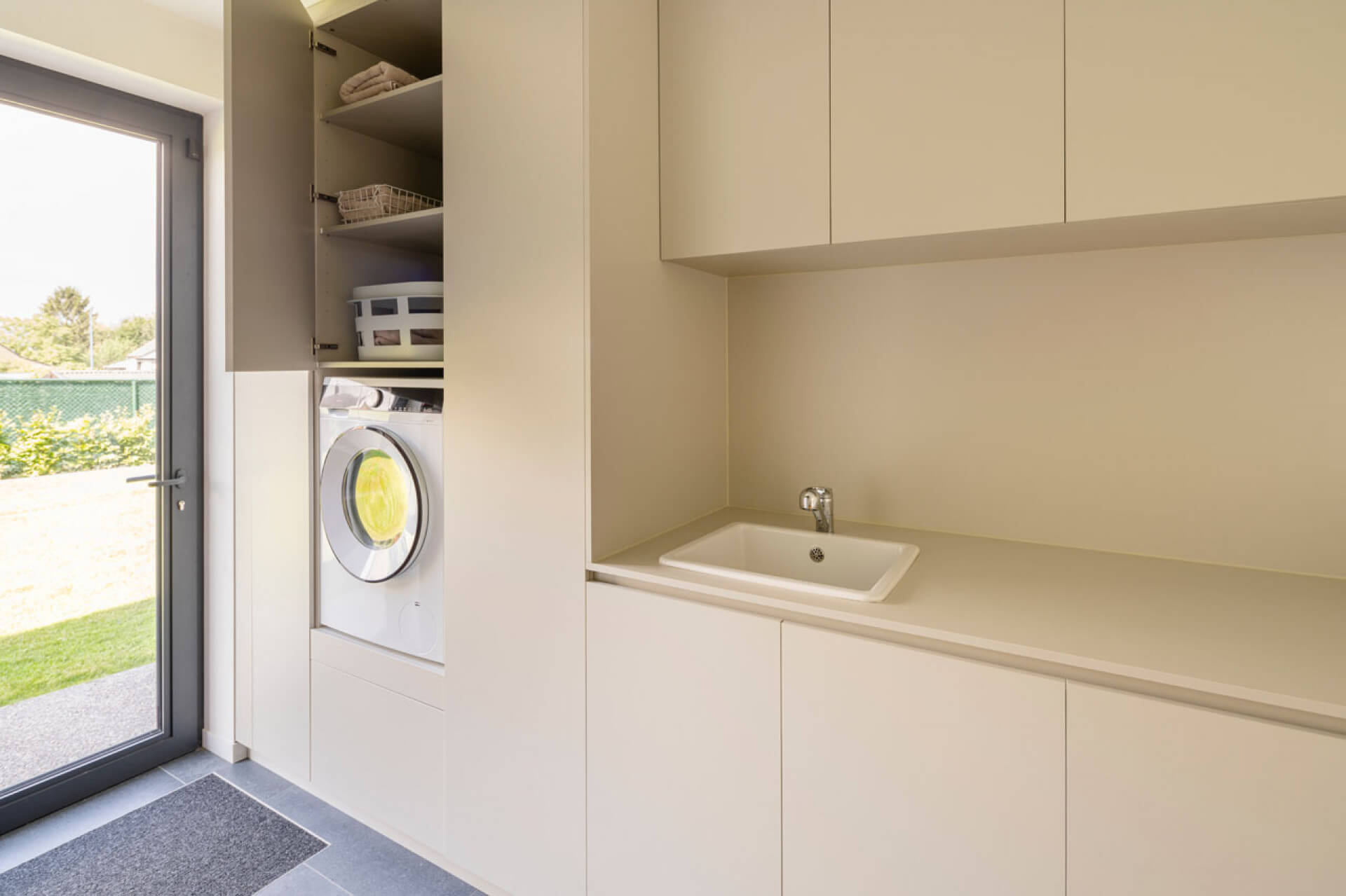 Wall unit of custom high and low cabinets in the laundry room