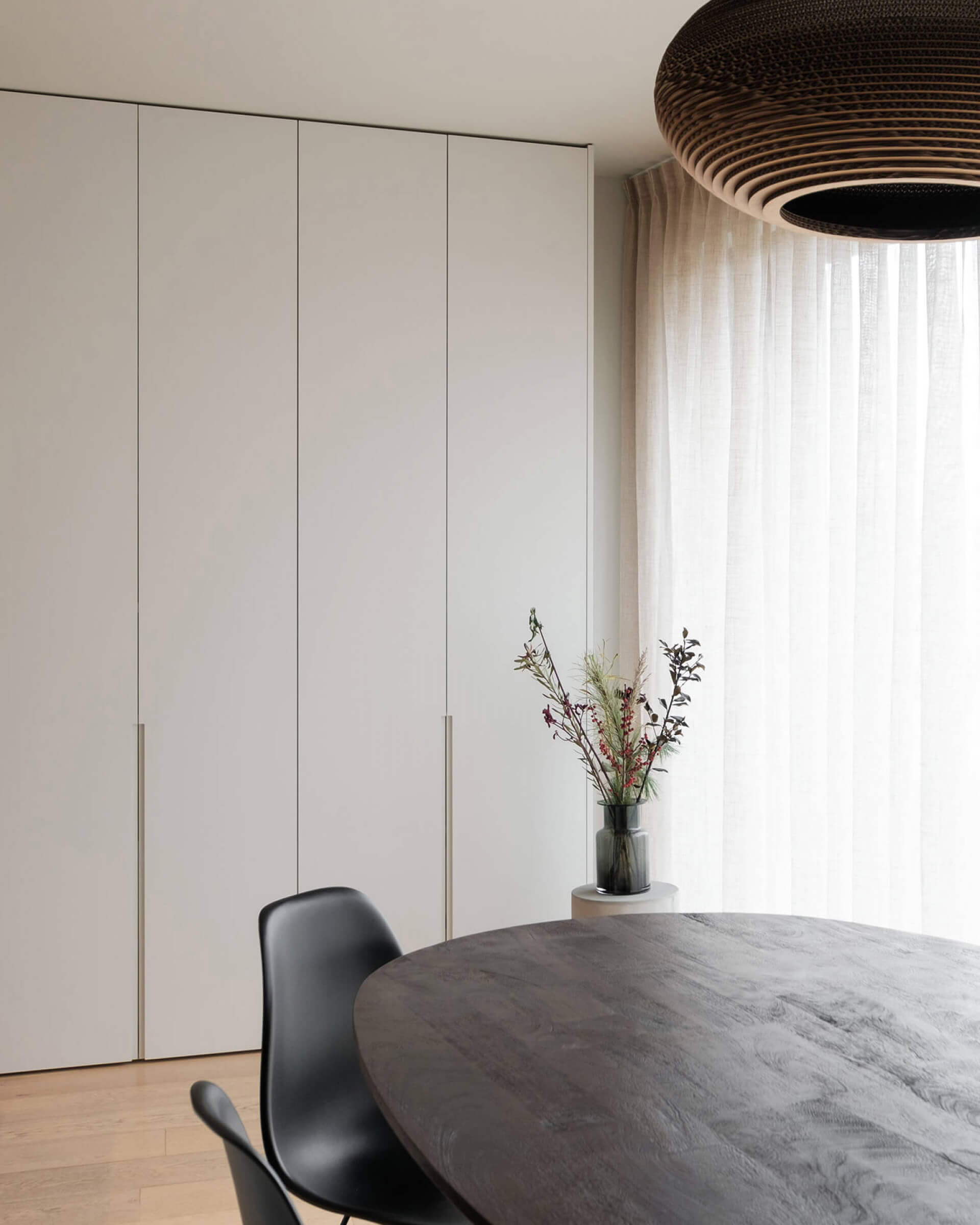  Custom-made storage cabinet with long milled handles on the cabinet doors