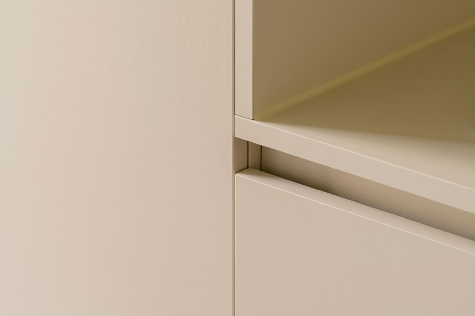 Detail of a wall unit with high and low cabinets in the color Turtle Grey