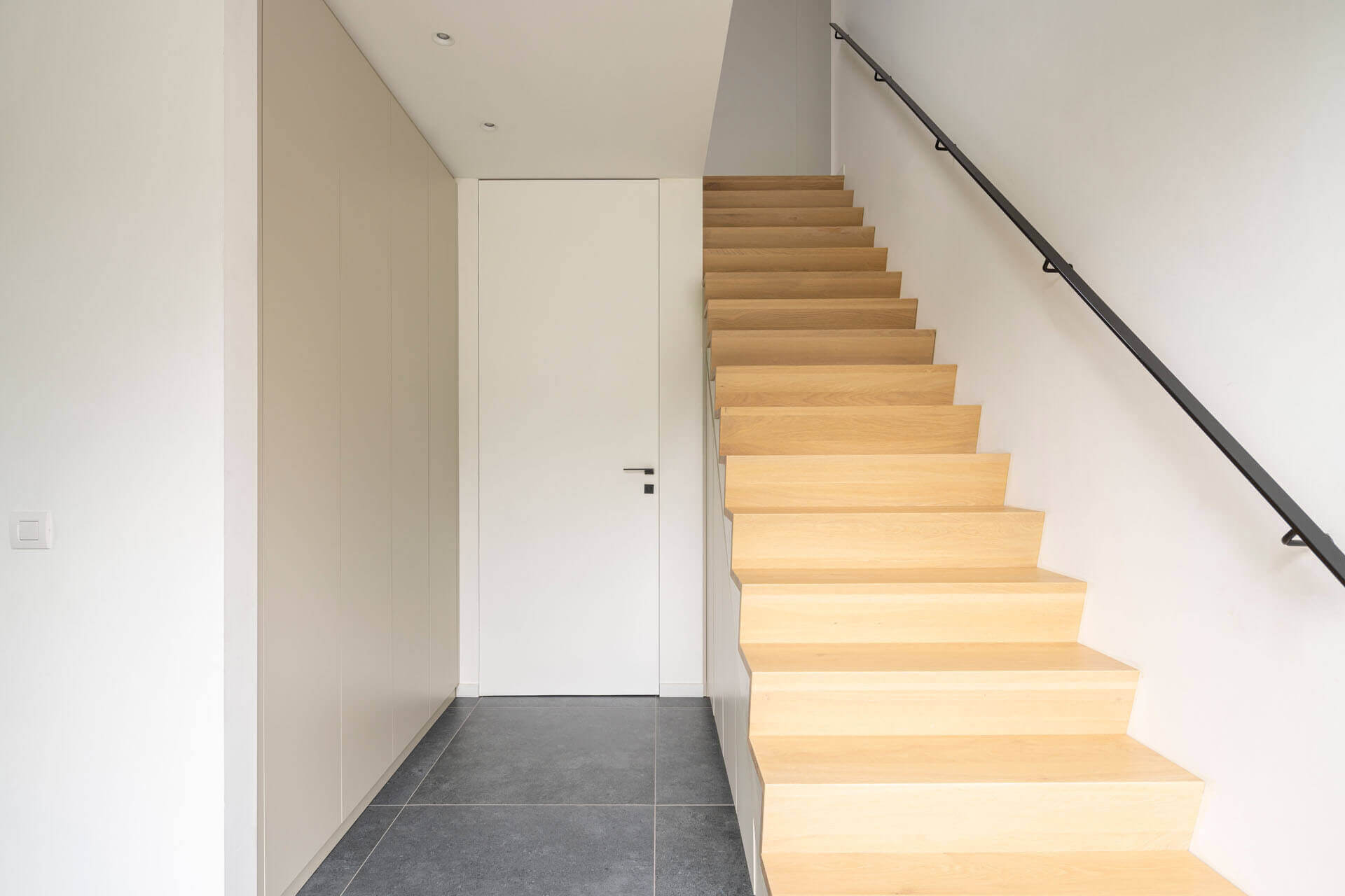 Custom hallway and staircase cabinet in the color Turtle Grey