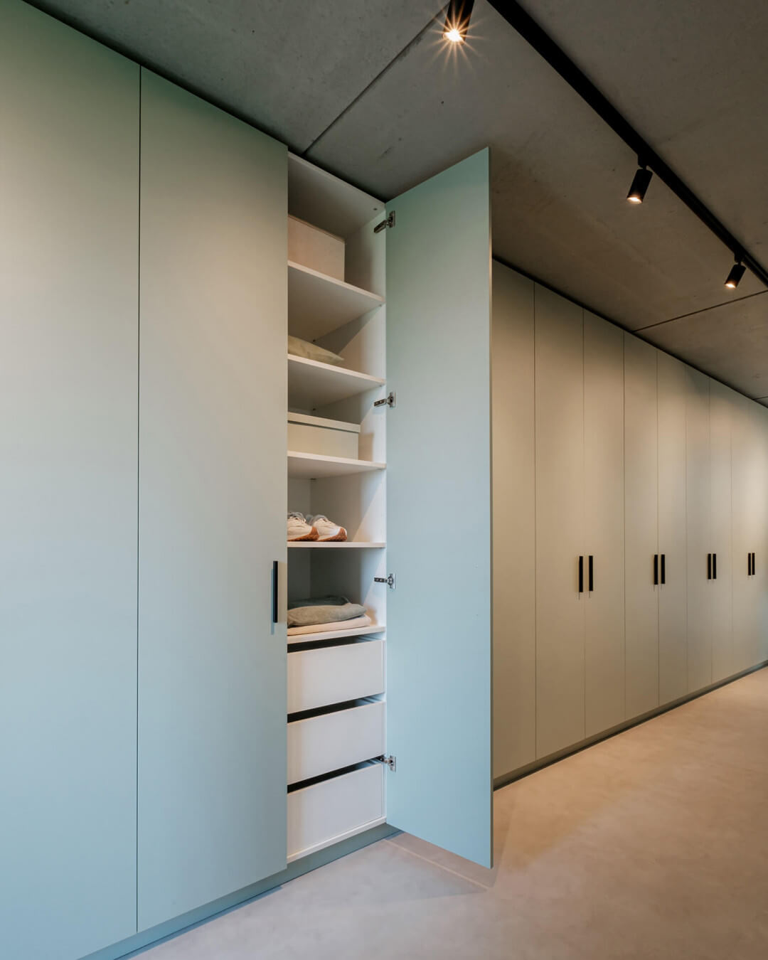 Bespoke storage cabinet in green with black handles