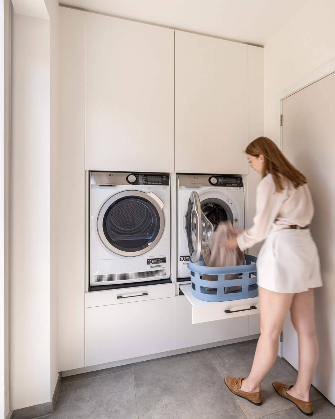 Custom laundry cabinet with pull-out shelf for your laundry basket