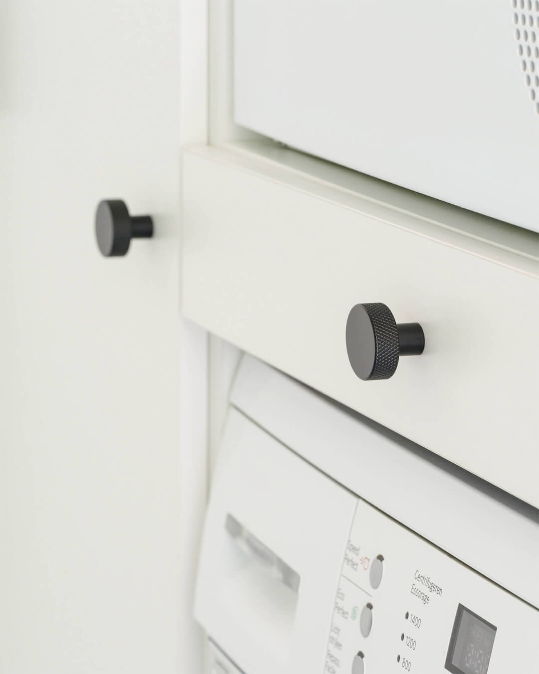 Button handles on a custom laundry cabinet