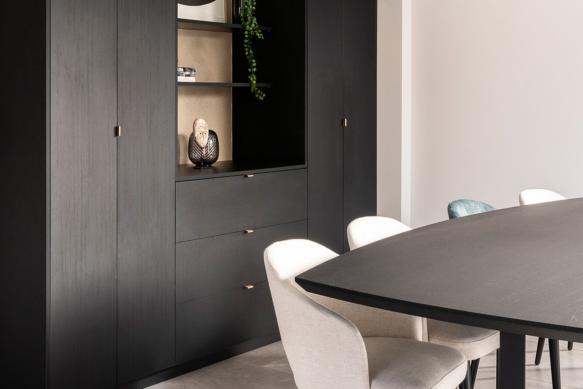 wall cupboard in living room with tall and low cupboard components in black wood structure 