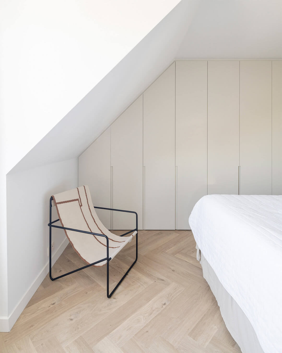 Custom-made wardrobe with long milled handles on the cabinet door