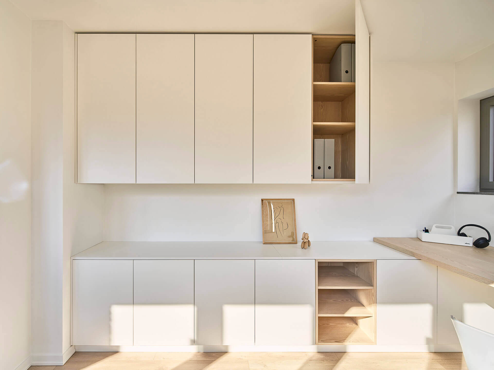 Custom ceiling cabinet above a desk in the color Front White